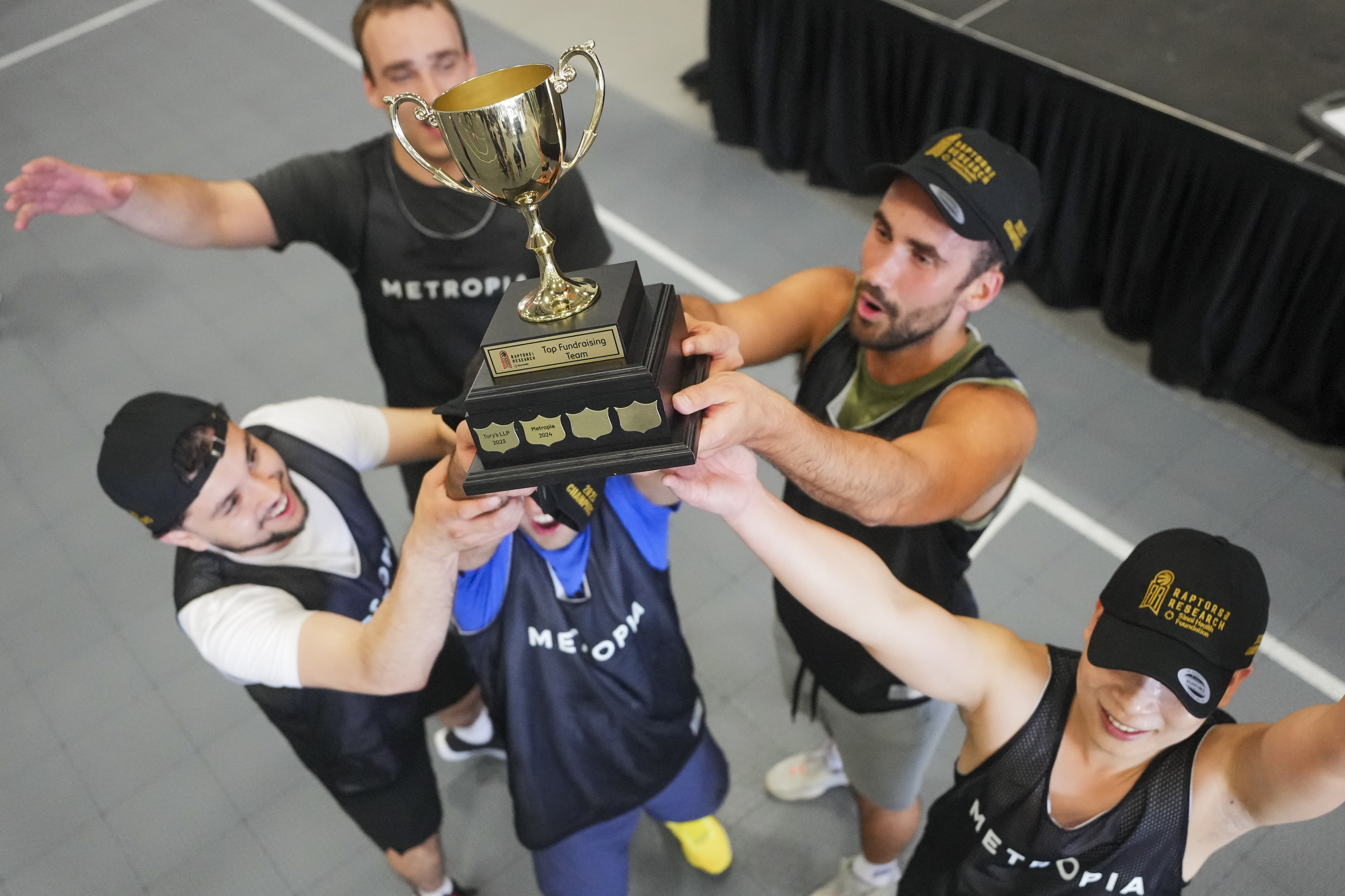 group of teammates holding a basketball